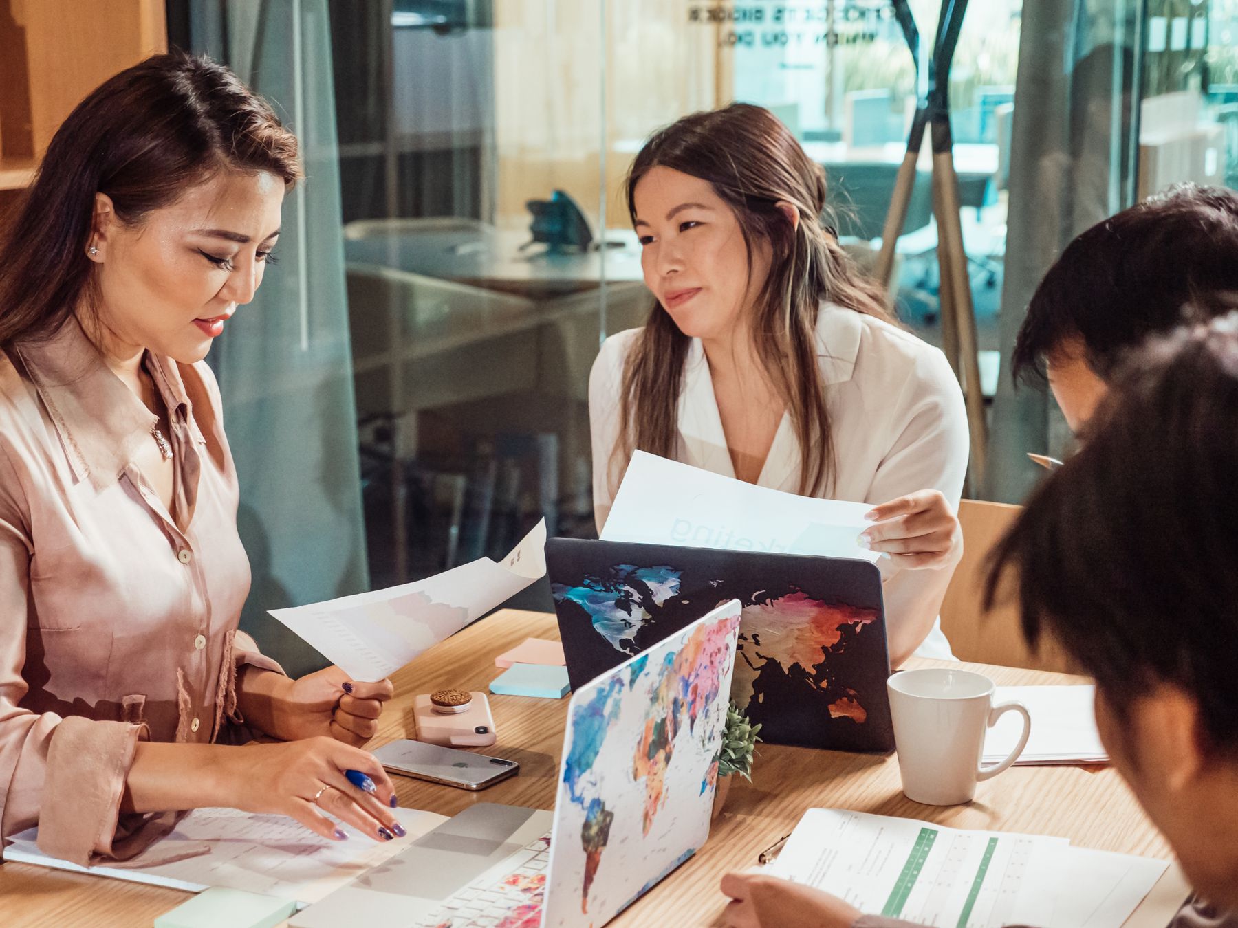 Asian professionals collaborating in a focused, positive business meeting