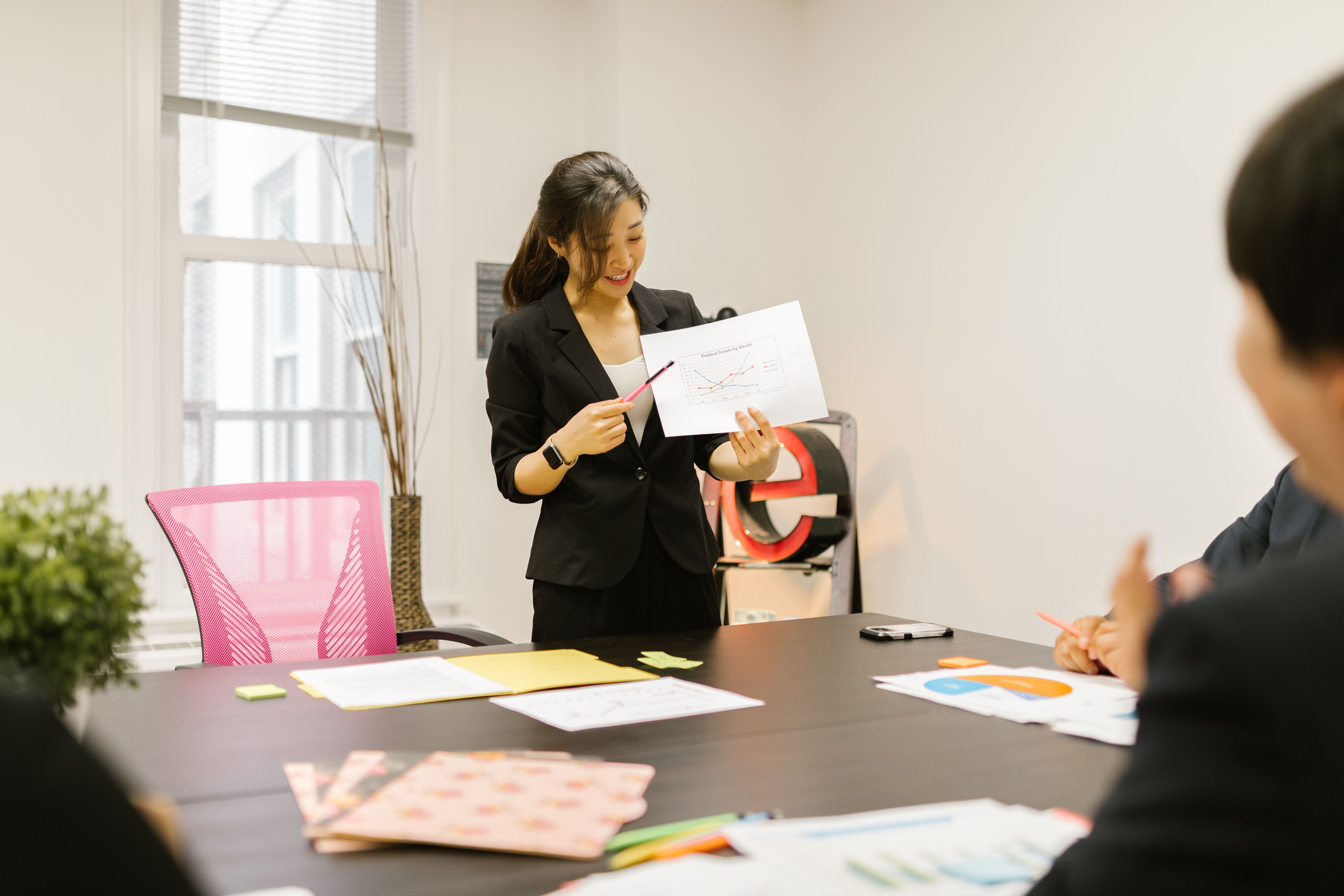 Asian business professional presenting data
